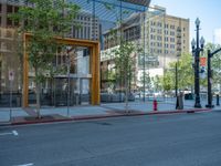 an empty street with buildings and parked cars on the sidewalks and green lanes on the sidewalk