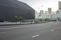 an empty freeway leading to a large city with tall buildings in the background / by richard _ c