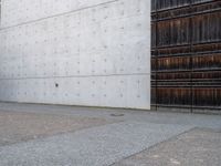 a person standing next to a wall in front of a door with an open door