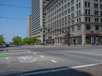 an intersection with buildings on both sides and a street light in the middle of the road