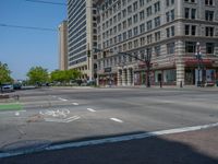 an intersection with buildings on both sides and a street light in the middle of the road