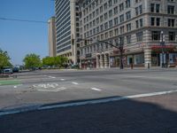 an intersection with buildings on both sides and a street light in the middle of the road