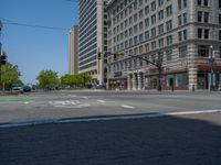 an intersection with buildings on both sides and a street light in the middle of the road