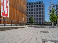 a group of people riding skateboards near wooden panels and stairss with artwork on them