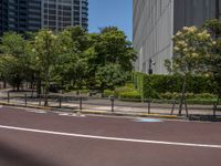 empty road with white lines on the streets of city area against cloudy blue sky on a sunny day