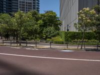 empty road with white lines on the streets of city area against cloudy blue sky on a sunny day