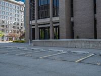 a street with a building near the building in the middle and on the left of which is a parking lot, as shown in this photo