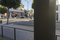 a parking meter is on the corner of a street corner on an sunny day next to a storefront