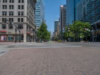 an intersection with buildings on both sides and a street light in the middle of the road