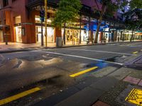 a street with a bus stoplight and a storefront with its lights on at night