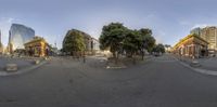 360 - panorama shot of city street with trees and people walking around in it on a sunny day