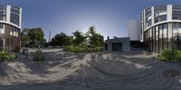 a fish - eye view of a building with lots of windows, trees and a building