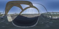 this is an fish eye lens looking at the traffic crossing with its curved sides and metal structures