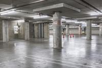 an empty parking garage with parking spaces and signs on the floor and walls are marked