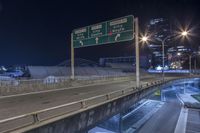 an exit sign on an interstate highway at night in the city of denver, colorado