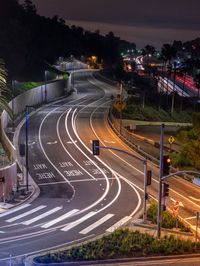 traffic on the street at night from a high vantage at night time near the street sign