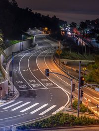 traffic on the street at night from a high vantage at night time near the street sign