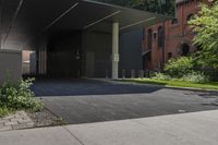 this is an outside building with a building in the background and trees growing on the curb