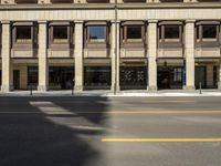 a picture of an old looking building next to the street with traffic signal on it