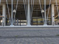 this is a large building with metal pipes on the front and floors, and a sidewalk in front