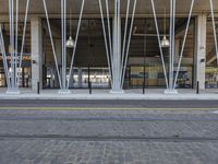 this is a large building with metal pipes on the front and floors, and a sidewalk in front