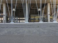 this is a large building with metal pipes on the front and floors, and a sidewalk in front