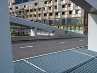 a motorcycle is parked in front of a modern office building and highway, as the city can't handle any of the traffic