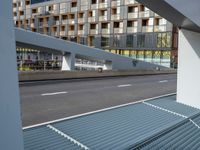 a motorcycle is parked in front of a modern office building and highway, as the city can't handle any of the traffic