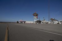 a motel in a city near the desert with buildings around it and a sign for days