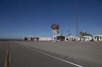 a motel in a city near the desert with buildings around it and a sign for days