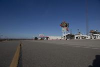 a motel in a city near the desert with buildings around it and a sign for days