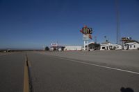 a motel in a city near the desert with buildings around it and a sign for days