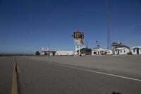 a motel in a city near the desert with buildings around it and a sign for days