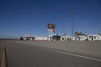 a motel in a city near the desert with buildings around it and a sign for days