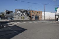 a large mural of an old woman in a black and white painting is on a building in a city street