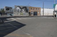 a large mural of an old woman in a black and white painting is on a building in a city street