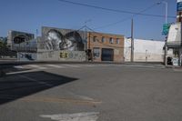 a large mural of an old woman in a black and white painting is on a building in a city street