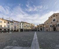 there is an empty square surrounded by many old buildings in this small town area of italy