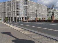 the empty street has signs on it in front of some buildings in a european city