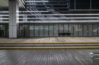 this is a photograph of a empty wooden platform in an empty room outside a building