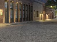 an image of city street in the evening light on cobblestone pavement with a fire hydrant