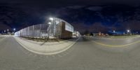 the view from a fish eye lens on a street corner in the city at night