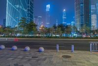 a city street with buildings and neon lights at night time in hong china as seen from an empty city highway