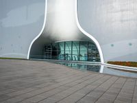 a white building that has a circular window and a small staircase to the front of it