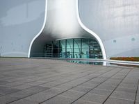 a white building that has a circular window and a small staircase to the front of it