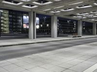 a person is sitting on the side walk looking at an empty street at night time