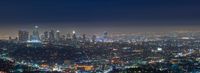 an aerial view of the city of los angeles at night with bright lights of buildings