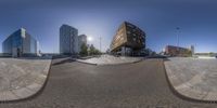 a panorama of buildings and a walkway as seen from a fisheye lenser's point of view