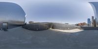 an image of a man skateboarding in the city park in a 360 - view mirror