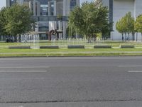 an empty street with buildings and trees in the background in a city park or a few streets